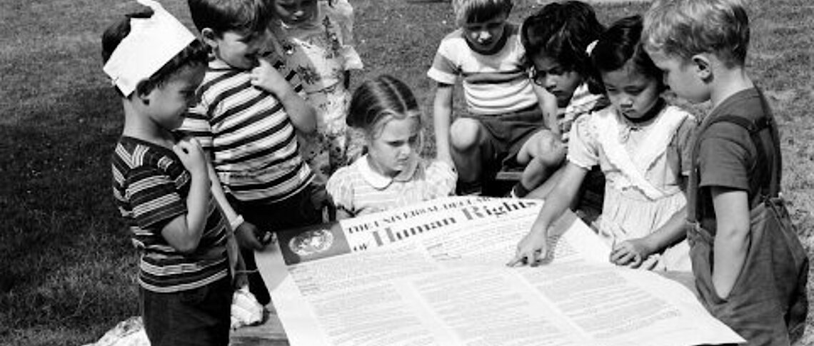 These children of United Nations staff members are getting a closer look at the Universal Declaration of Human Rights. UN Photo