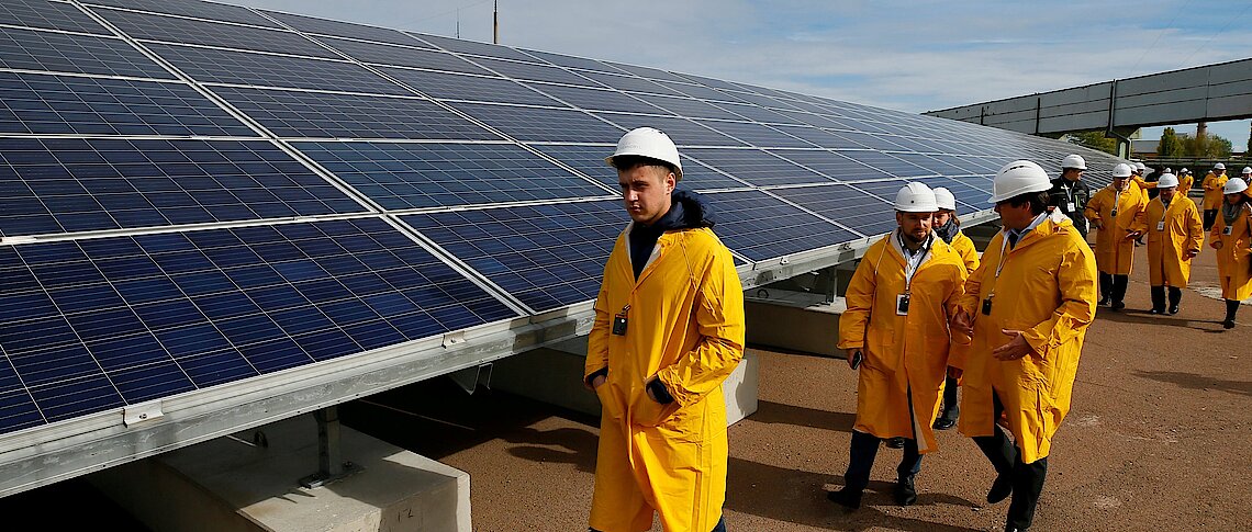 Old and new: sisitors walk past solar panels on the site of the world's worst nuclear disaster in Chernobyl Reuters