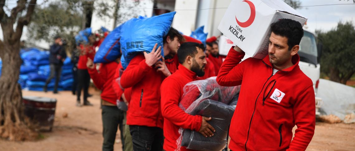 Volunteers distributing humanitarian aid in the Kafr Yahmoul camps in Idlib countryside, north-western Syria Reuters