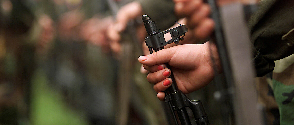 A Colombian guerilla woman holds her gun as she takes part in a line of rebels during an army parade of FARC fighters Reuters