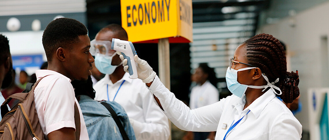 A health worker checks the temperature of a traveller as part of the coronavirus screening procedure Reuters