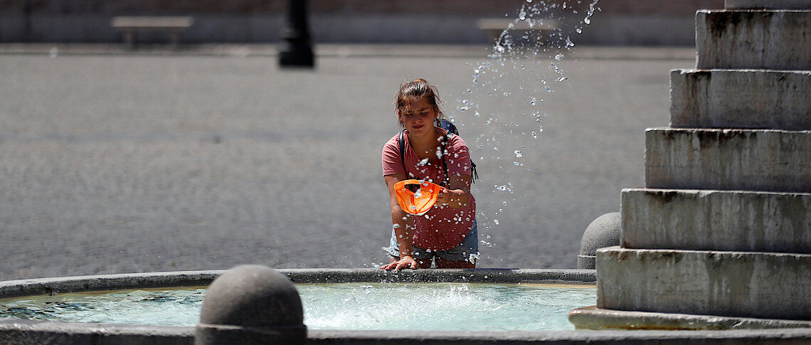 A girl cools off at a fountain in Piazza del Popolo during hot weather in Rome Reuters